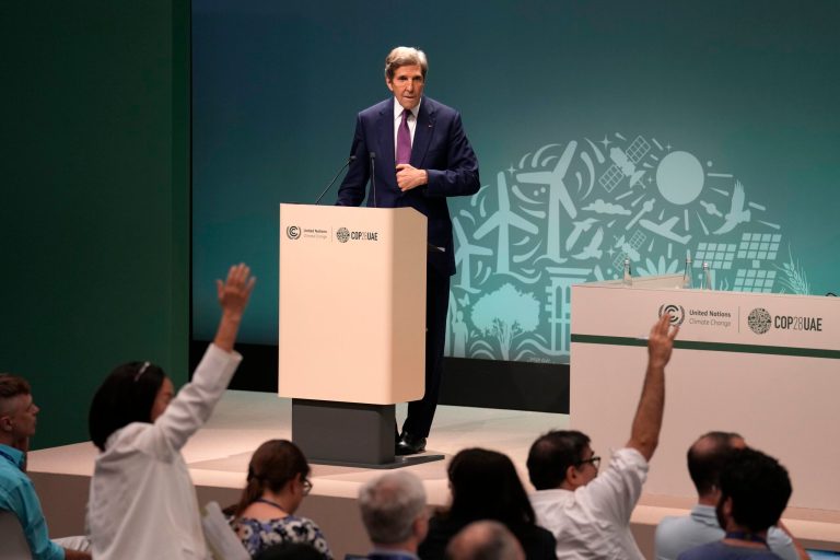 Journalists try to ask John Kerry, U.S. special presidential envoy for climate, questions during a news conference at COP28, Wednesday, Dec. 6, 2023, in Dubai, United Arab Emirates.