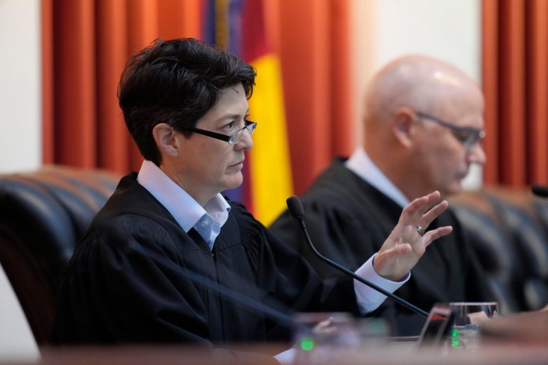 Colorado Supreme Court Justice Monica M. Marquez, front, makes a point as Chief Justice Brian D. Boatright listens during a hearing on Wednesday, Dec. 6, 2023, in Denver. The oral arguments before the court were held after both sides appealed a ruling by a Denver district judge on whether to allow former President Donald Trump to be included on the state's general election ballot.