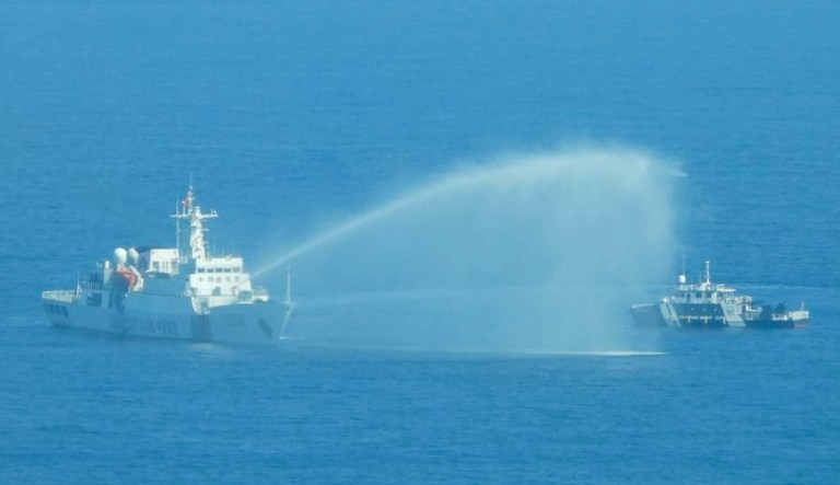 In this photo provided by the Philippine Coast Guard, a Chinese Coast Guard ship, left, uses its water cannons on a Philippine Bureau of Fisheries and Aquatic Resources vessel as it approaches Scarborough Shoal in the disputed South China Sea on Dec. 9, 2023. The Philippines and its treaty ally, the United States, separately condemned a high-seas assault Saturday by the Chinese coast guard and suspected militia ships that repeatedly blasted water cannons to block three Philippine fisheries vessels from a disputed shoal in the South China Sea. 