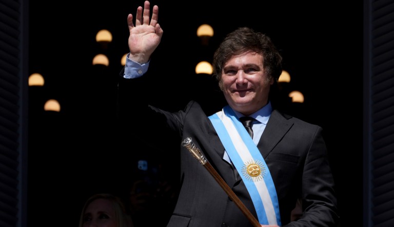 Argentina's newly sworn-in President Javier Milei waves to supporters from the balcony of the government house in Buenos Aires, Argentina, Sunday, Dec. 10, 2023.
