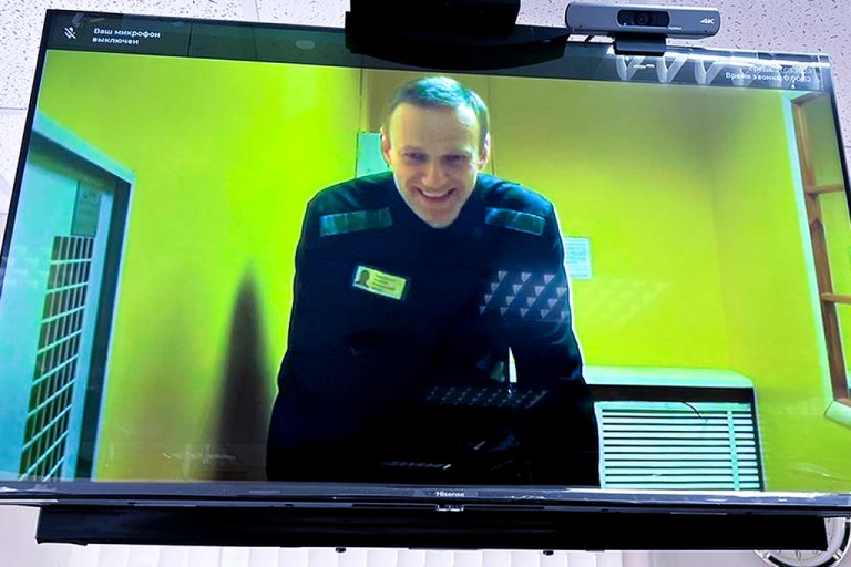 FILE - In this handout photo released by Moscow City Court Press Service, Alexei Navalny is seen on a TV screen, as he appears in a video link provided by the Russian Federal Penitentiary Service in a courtroom at Moscow City Court in Moscow, Russia, on May 31, 2023. 