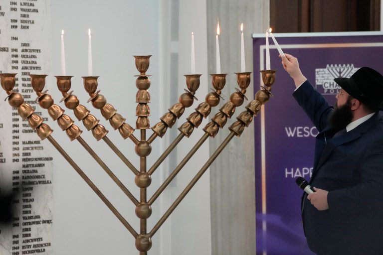 Far-right Polish lawmaker snuffs out Hanukkah candles in parliament with fire extinguisher