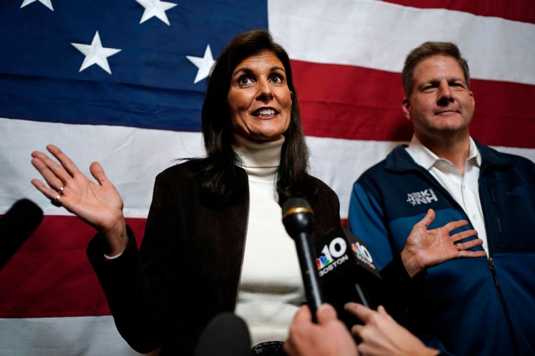 Republican presidential candidate Nikki Haley and Gov. Chris Sununu speak to reporters following a town hall campaign event, Dec. 12, 2023, in Manchester, N.H.