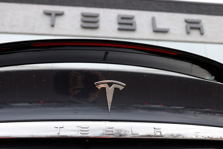 The Tesla company logo shines off the rear deck of an unsold 2020 Model X at a Tesla dealership on April 26, 2020, in Littleton, Colorado. Tesla is recalling more than 2 million vehicles across its model lineup to fix a defective system that is supposed to ensure drivers are paying attention when they use Autopilot. Documents posted by U.S. safety regulators say the company will send out a software update to fix the problems.