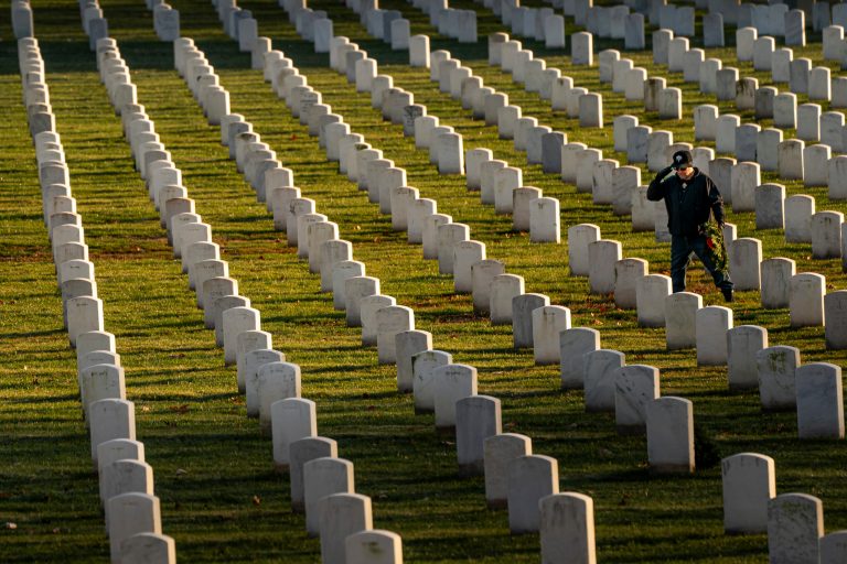 A man salutes after placing a wreath at Arlington National Cemetery on Saturday, Dec. 16, 2023, in Arlington, Virginia. A Confederate memorial is to be removed from the cemetery in the coming days, part of the push to remove symbols that commemorate the Confederacy from military-related facilities, a cemetery official said.