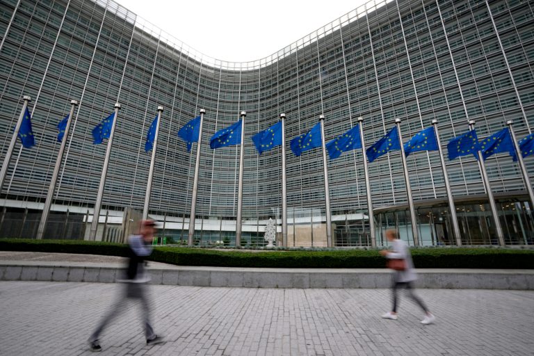 European Union flags wave in the wind as pedestrians walk by EU headquarters in Brussels, on Sept. 20, 2023. Three of the world's biggest pornography websites face new requirements in the European Union including verifying the ages of users, the bloc said Wednesday, Dec. 20, 2023, as it expanded the reach of its digital law designed to keep people safe on the internet. 