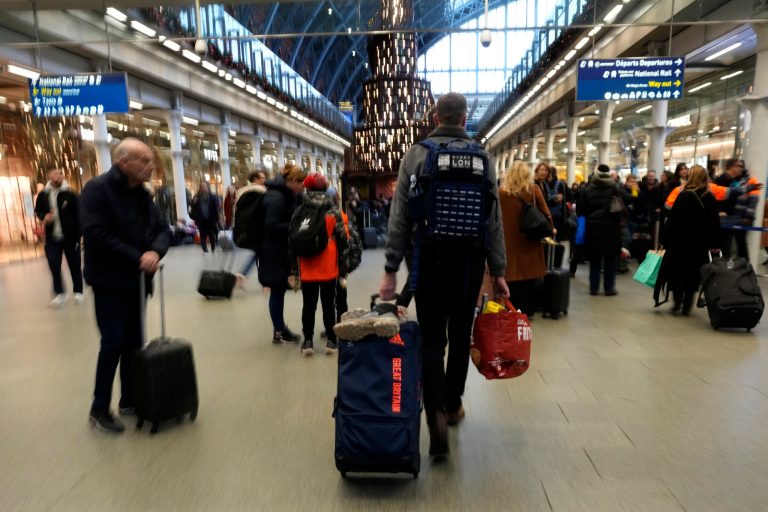 Travelers queue for the Eurostar trains at St. Pancras Station in London, Friday, Dec. 22, 2023. Eurostar was hit Thursday by an unofficial strike in northern France, which led to the cancellation of most services. With full trains leading up to Christmas those travellers affected by the strike will have to find alternative ways to their destination. 