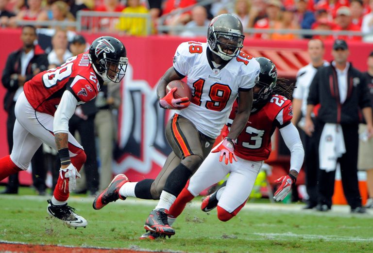 Tampa Bay Buccaneers wide receiver Mike Williams (19) finds room to run between Atlanta Falcons free safety Thomas DeCoud (28) and cornerback Dunta Robinson (23) during an NFL football game Sunday, Sept. 25, 2011, in Tampa, Florida. Williams died from a rare form of sepsis infection related to dental health problems, according to a medical examinerâs report, Friday, Dec. 22, 2023. Williams, 36, died Sept. 12 after he was initially hospitalized following a construction accident while working as an electrician.