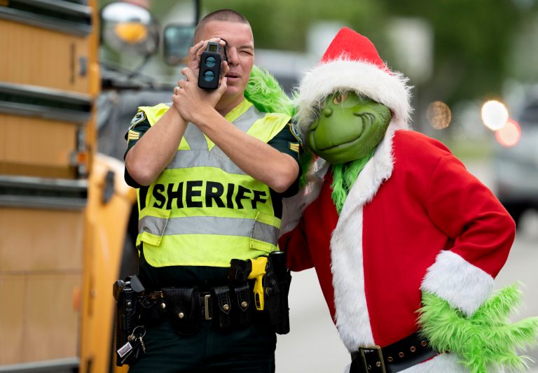 Florida police officer in Grinch costume offers onions for speeding violations