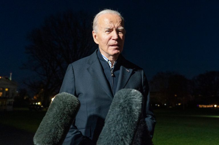 FILE - President Joe Biden answers a reporter's question as he walks from Marine One upon arrival on the South Lawn of the White House, Dec. 20, 2023, in Washington. (AP Photo/Alex Brandon, File)