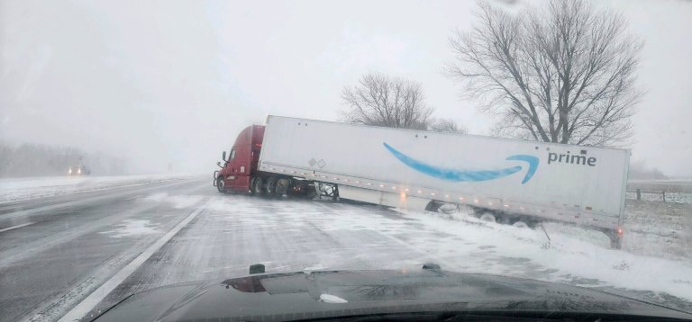 In this photo provided by Nebraska State Patrol, a tractor trailer veers into ditch on Christmas Day on Interstate 80 in Nebraska as a winter storm pummels part of the Midwest, on Monday, Dec. 25, 2023. 