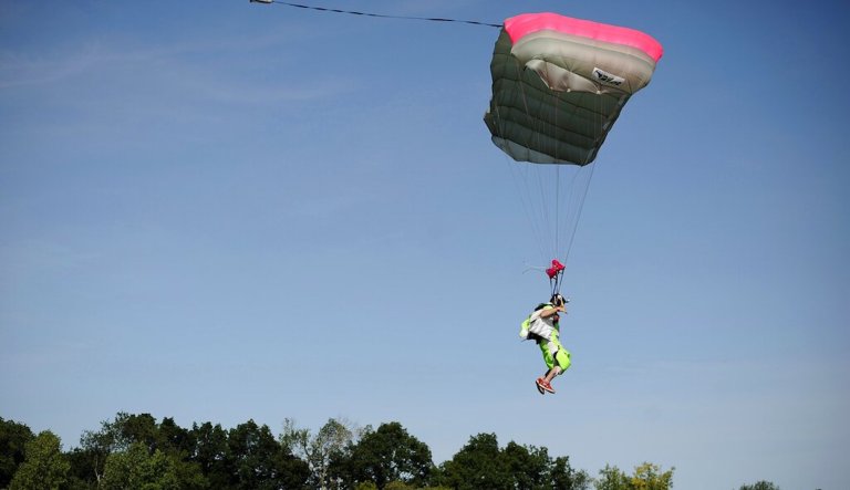 In this Friday, Aug. 7, 2015 photo, a parachutist comes in for a landing at the Ellington Airport, in Ellington, Conn.