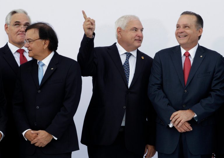 Panama's President Ricardo Martinelli, second from right, talks with the former administrator of the Panama Canal, Alberto Aleman Zubieta, right, as Canal Affairs Minister Roberto Roy, second from left, and newly designed Panama Canal Administrator Jorge L. Quijano, left behind, look on before the inaugural ceremony for Quijano in Panama City, Tuesday, Sept. 4, 2012.
