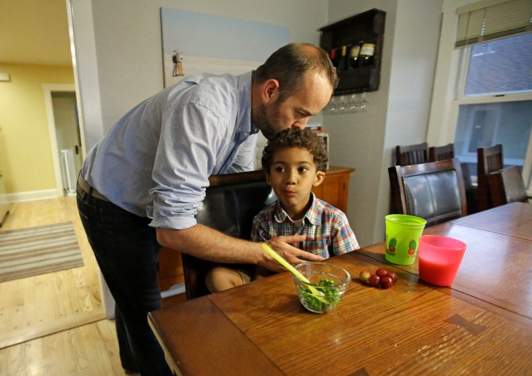 Weston Clark kisses his son Xander, 4. Fatherhood has been exhilarating for Clark, who put aside a teaching career to be a stay-at-home dad.