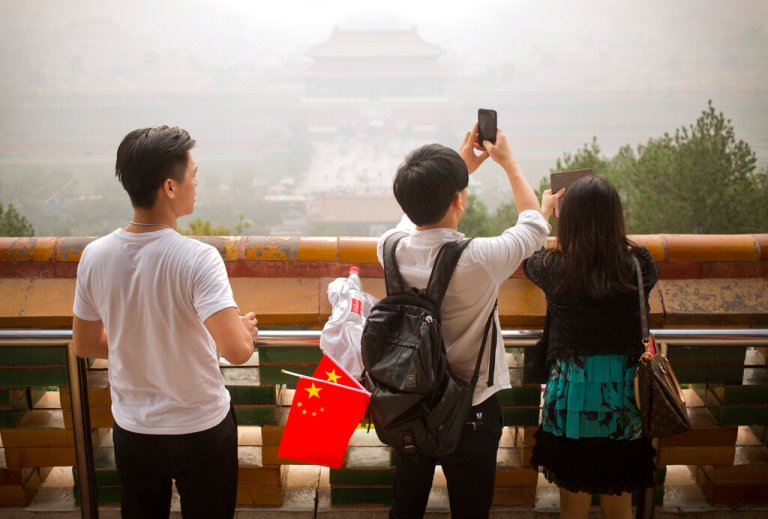Chinese residents using a mobile device.