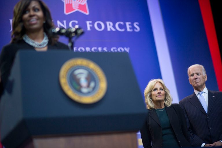 Former Vice President Joe Biden, right, and his wife Jill Biden, center, listen to former first lady Michelle Obama, left, speak as they help kick off the 5th anniversary of Joining Forces in May 2016. Odds are starting to favor Obama as Biden's running mate.