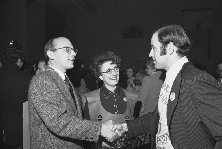Sen. Joseph Biden, D-Del., right, shakes hands with Adlai E. Stevenson III, D-Ill., April 6, 1974, during the first annual Counter Gridiron party in Washington. Watching is Miss Ruth Dean of Washington.