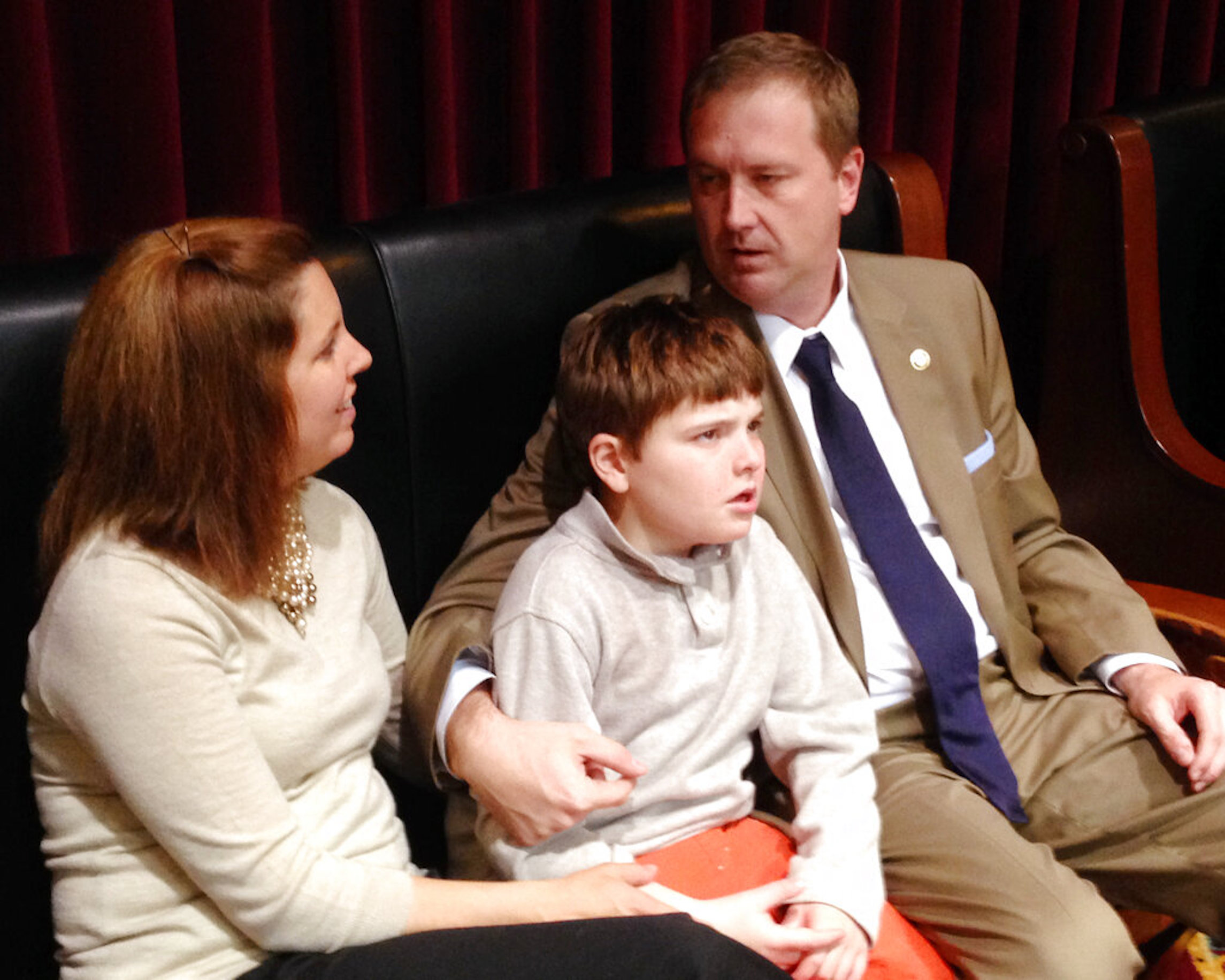 Republican Missouri Sen. Eric Schmitt, his wife Jaime Schmitt and their son Stephen Schmitt, who has epilepsy, watch state House debate in Jefferson City, Mo., on Thursday, May 1, 2014. State lawmakers sent a bill to the governor handled by Schmitt that would allow use of a cannabis extract by people whose epilepsy isn’t relieved by other treatments.