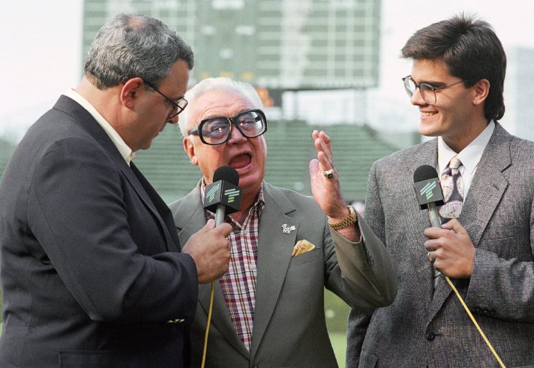 Harry Carey, middle, jokes around with his son, Skip, left, and grandson Chip during a pre-game television show from Wrigley Field, May 13, 1991.