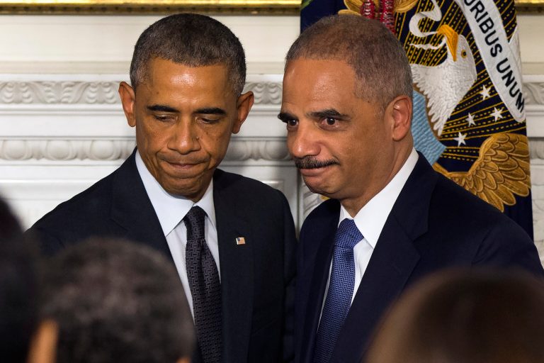 Audience members applaud Attorney General Eric Holder, right, and President Barack Obama during an announcement in the State Dining Room of the White House to announce Holder is resigning, on Thursday, Sept. 25, 2014, in Washington.