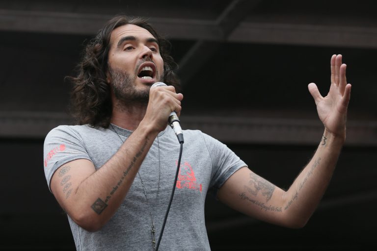 Comedian Russell Brand speaks in Parliament Square during a protest against the Conservative Government and it's austerity policies in London, Saturday, June 20, 2015.  