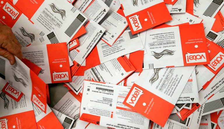 Election workers begin to sort a new batch of ballots collected earlier in the day from drop boxes at the King County elections office, Monday, Nov. 5, 2018, in Renton, Wash.