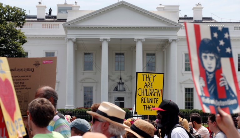 Activists march past the White House to protest the Trump administration's approach to illegal border crossings and separation of children from immigrant parents, Saturday, June 30, 2018, in Washington.            