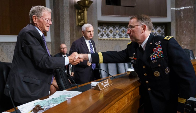 Gen. Robert Abrams, right, shakes hands with Senate Armed Services Committee Chairman Sen. James Inhofe, R-Ok., left, as ranking member Sen. Jack Reed, D-R.I., stands center, after a hearing on Capitol Hill in Washington, Tuesday, Sept. 25, 2018. 