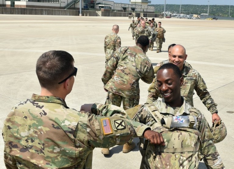 Col. Robert Howe, the 1st Medical Brigade Commander, sends off soldiers from the 9th Hospital Center deploying from Fort Hood, Texas to the New York City area with an elbow bump, Mar. 26, 2020, where they will begin augmenting the local medical professionals in the fight against COVID-19.