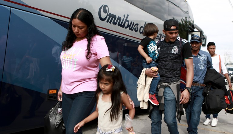 Central American migrants prepare to board a bus as they voluntarily return to their countries, in Ciudad Juarez, Mexico, Tuesday, July 2, 2019.