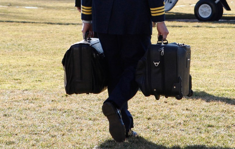 The "football," which is carried everywhere the president goes by a military aide, contains the nuclear codes. (AP Photo/Ron Edmonds)