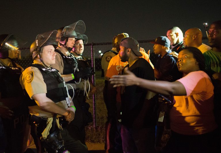 Demonstrators, marking the one-year anniversary of the shooting of Michael Brown, confront police during a protest along West Florrisant Street on August 10, 2015 in Ferguson, Missouri. (Photo by Scott Olson/Getty Images)
