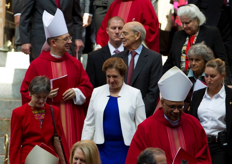 U.S. Supreme Court Justices Elena Kagan, center, and Stephen Breyer, center-right, leave the Cathedral of St. Matthew the Apostle with clergy after the annual Red Mass for Supreme Court justices in Washington, Sunday, Oct. 5, 2014. The new Supreme Court term starts Monday. (AP Photo/Jose Luis Magana)