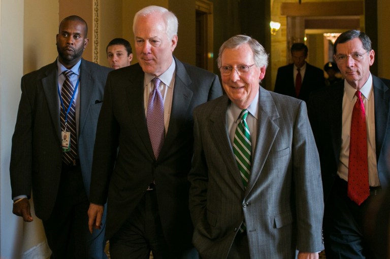 Senate Minority Whip John Cornin, R-Texas; Senate Minority Leader Mitch McConnell, R-Ky.; and Senator John Barrasso, R-Wyo, on their way to the Senate Floor. McConnell is under fire from the Senate Conservatives Fund, which has accused him of being a 