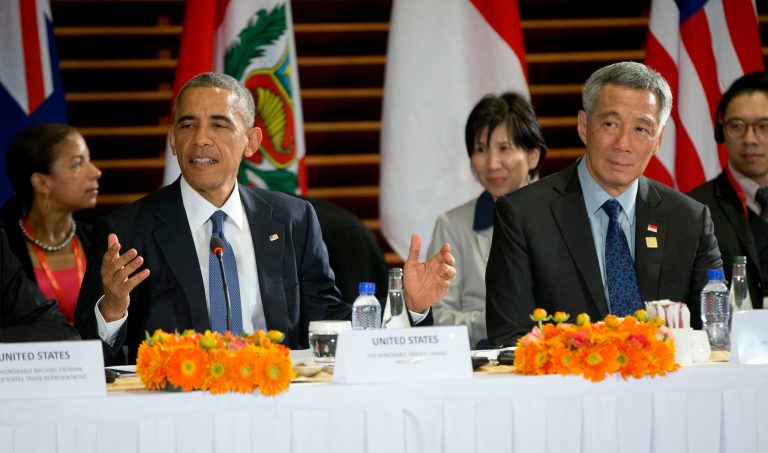 U.S. President Obama, left, speaks as he is seated with Singapore's Prime Minister Lee Hsien Loong, right, during a meeting with leaders of the Trans-Pacific Partnership countries. (AP Photo/Pablo Martinez Monsivais)