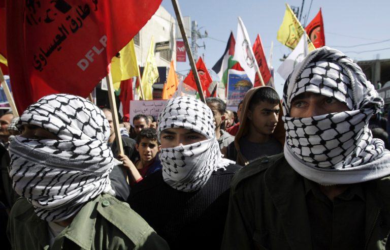 Men march in support of the Palestinian prisoners, in the West Bank city of Jenin, Tuesday, Feb. 26, 2013. Palestinians have been staging support rallies for nearly 4,600 prisoners held by Israel, particularly for four inmates who have been on extended hunger strikes. (AP Photo/Mohammed Ballas)