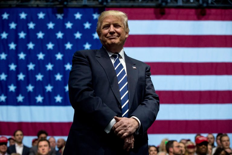 President-elect Donald Trump smiles as he listens to his pick for Education Secretary Betsy DeVos speak during a rally at DeltaPlex Arena, Friday, Dec. 9, 2016, in Grand Rapids, Mich. (AP Photo/Andrew Harnik)
