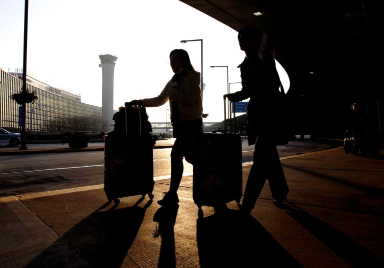FILE - In this Wednesday, Nov. 23, 2011, file photo, travelers, with luggage in hand, make their way toward Terminal A at O'Hare International Airport in Chicago.  The U.S Department of Homeland Security said Wednesday, Feb. 19, 2014, it is warning airlines that terrorists could try to hide explosives in shoes. It's the second time in less than three weeks that the government has issued a warning about possible attempts to smuggle explosives on a commercial jetliner. (AP Photo/Nam Y. Huh, File)