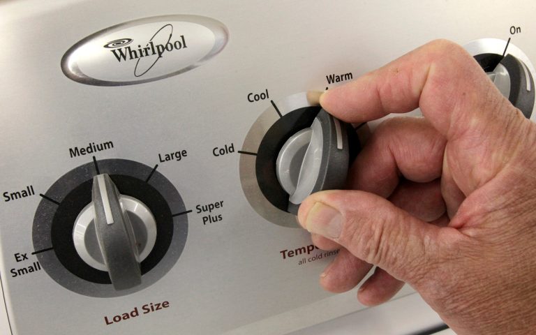 In this July 20, 2009, an unidentified employee shows off the dials on a Whirlpool top load washing machine at the Sears Grand store in Solon, Ohio. (AP Photo/Amy Sancetta)