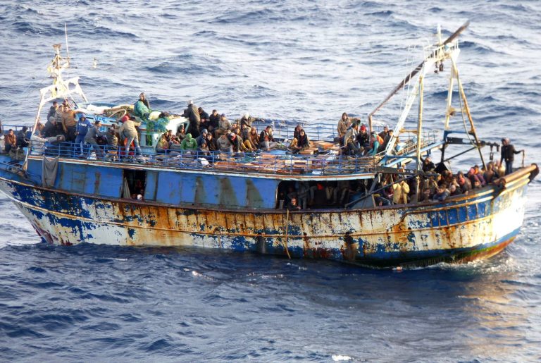 In this image released by the Greek Coast Guard, a stranded fishing boat carrying some 331 immigrants, including 40 children and 24 women, prior to being transferred to an oil tanker on Monday March 31, 2014, after the fishing boat made a distress call overnight.  The transfer was overseen by the Greek Coast Guard and lasted several hours in moderate-to-rough seas between the islands of Crete and Kythira, the Merchant Marine Ministry said.  (AP Photo/Hellenic Coast Guard)