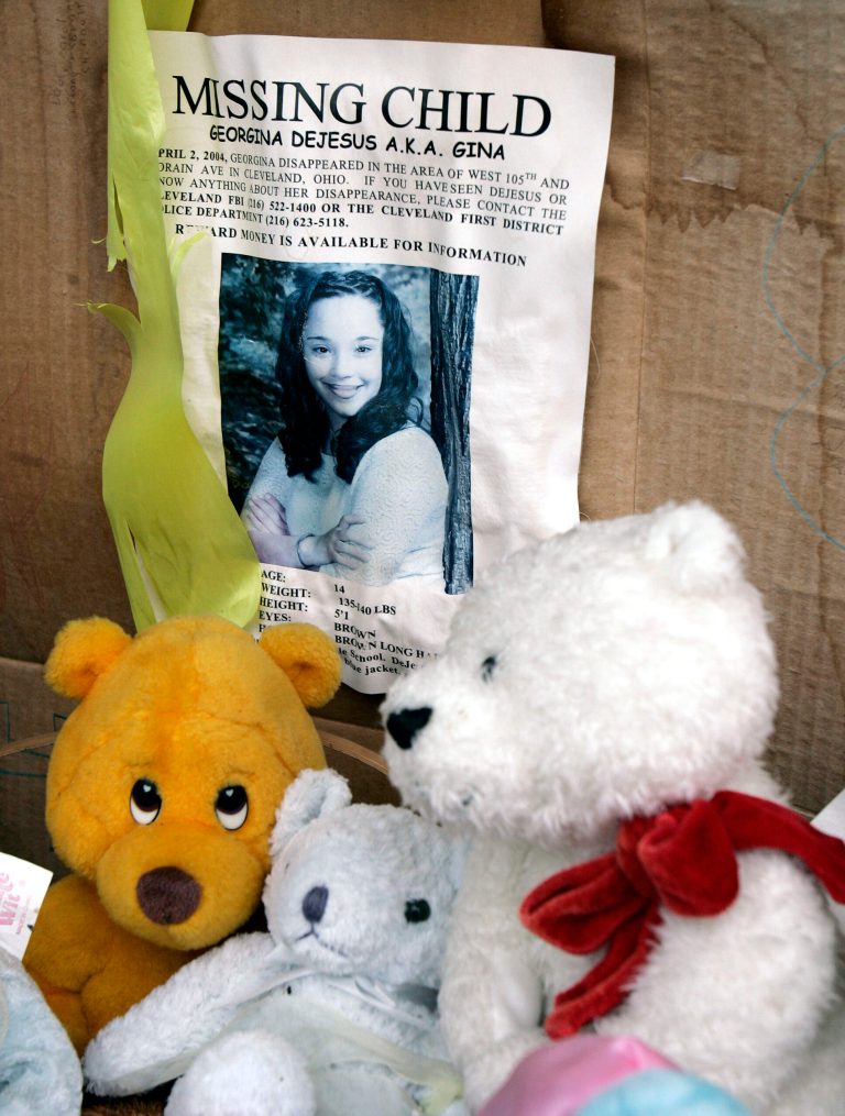 FILE - In this March 3, 2006 file photo, a memorial for Gina DeJesus, who has been missing since April 2, 2004, rests alongside her house in Cleveland. Cleveland police say DeJesus, one of two women who went missing as teenagers about a decade ago has been found alive in a residential area about two miles (three kilometers) south of downtown. (AP Photo/Tony Dejak, File)