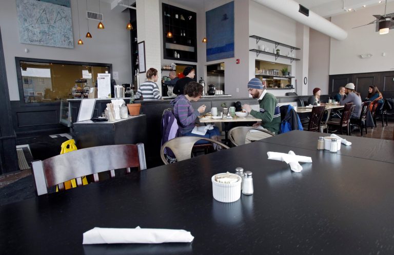 In this Tuesday, Jan. 28, 2014 photo, customers eat lunch at Bonbon Pastry and Cafe in Cleveland. Single-digit temperatures across the U.S. and record snowfalls in the Midwest since the beginning of January have put the freeze on businesses that rely on walk-ins and appointments. At the cafe in the city's Market Square district, this past weekend was especially slow with whiteout conditions making going outside unappealing for customers. (AP Photo)