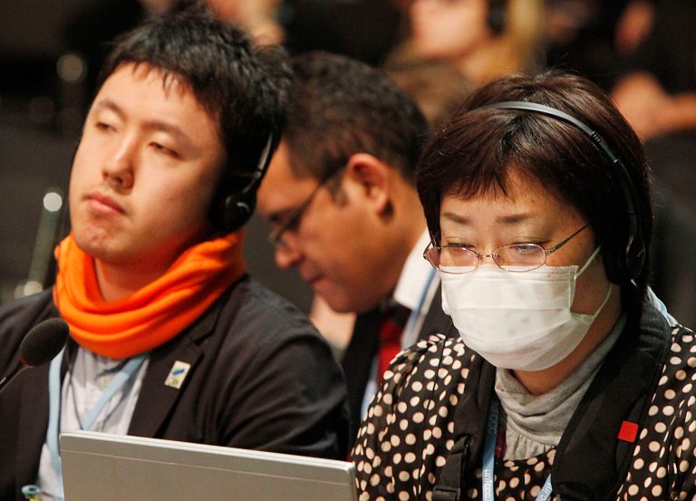 Unidentified delegates listen to a translated commentary during the closing session of the U.N. Climate Change talks in Warsaw, Poland, Saturday. (AP/Czarek Sokolowski)
