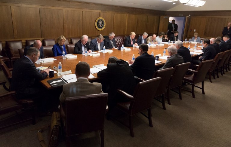The White House released a photo late Saturday afternoon of President Trump and members of his Cabinet bowing their heads in prayer as they met at Camp David in Maryland. (Official White House Photo by Shealah Craighead)