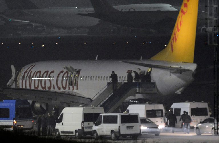 Passengers of private Turkish company Pegasus leave the plane at the Sabiha Gokcen Airport in Istanbul, Turkey, Friday, Feb. 7, 2014. An official says authorities have subdued a man who attempted to hijack a Turkish plane to Sochi, Russia, and that the other passengers have been evacuated. Huseyin Avni Mutlu, the Istanbul governor, says on Twitter that 