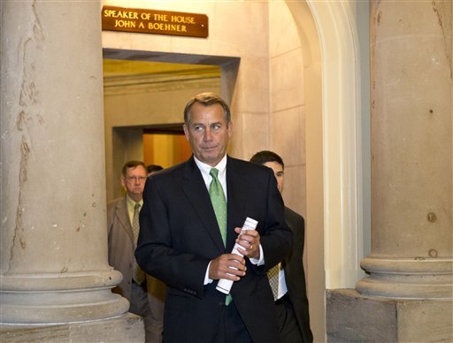 FILE - In this Tuesday, Dec. 11, 2012, file photo, House Speaker John Boehner of Ohio leaves his office and walks to the House floor to deliver remarks about negotiations with President Obama on the fiscal cliff, on Capitol Hill in Washington. Even if Congress and the White House fail to strike a budget deal by New Year's Day, reality may be a lot less bleak then the scenario that's been spooking employers and investors and slowing the U.S. Economy. The tax increases and spending cuts could be retroactively repealed after Jan. (AP Photo/J. Scott Applewhite)