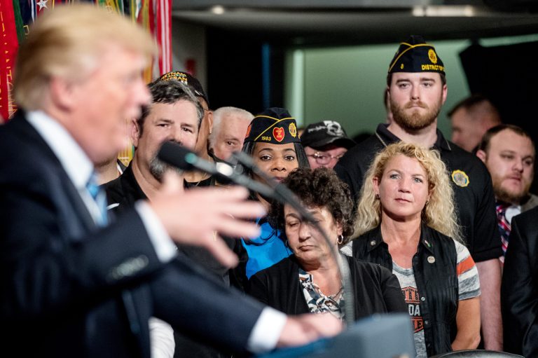 Veterans listen as President Trump speaks before signing an Executive Order on 
