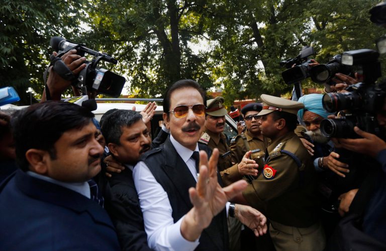 FILE - In this Tuesday, March 4, 2014 file photo, head of Sahara India conglomerate Subrata Roy speaks to the media as he arrives at the Supreme Court for a hearing in New Delhi, India. India's Supreme Court has rejected an appeal by the Indian tycoon accused of a multibillion dollar fraud to be released from jail and allowed house arrest. Roy has been jailed since the end of February on charges that his company failed to return billions of dollars to investors. (AP Photo/Altaf Qadri, File)