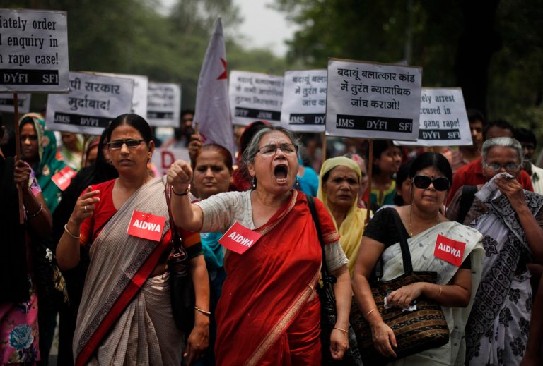 Members of the All India Democratic Women's Association (AIDWA) shout slogans during a protest against the gang rape of two teenage girls, in New Delhi, India, Saturday, May 31, 2014. Police arrested a third suspect and hunted for two others Saturday in the gang rape and slaying of two teenage cousins found hanging from a tree in Katra village, in the northern Indian state of Uttar Pradesh, a case that has prompted national outrage. The placard reads 'Arrest all accused in the gang rape.
