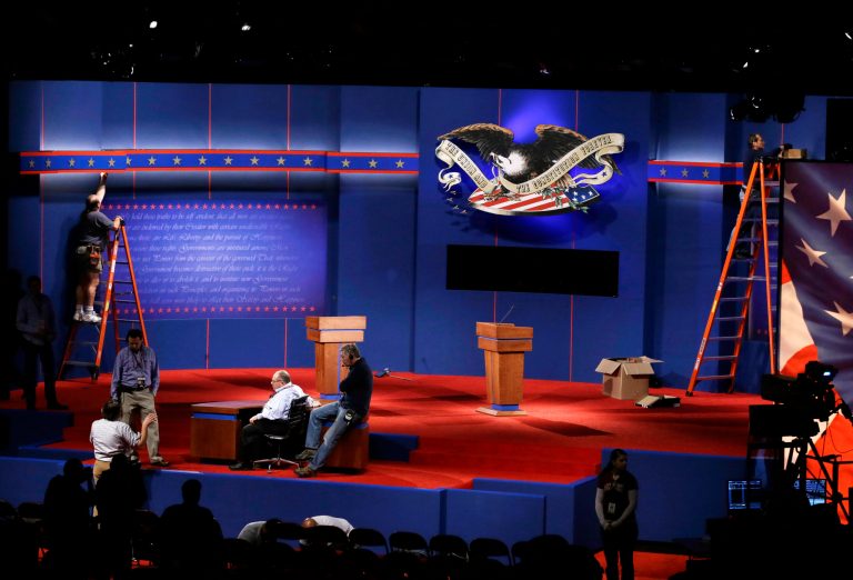 Workers set up the stage in the Magness Arena. (AP Photo)